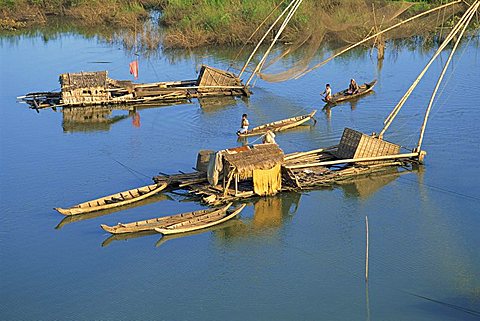 Fishing rafts and fishermen on canoes in Cambodia, Indochina, Southeast Asia, Asia