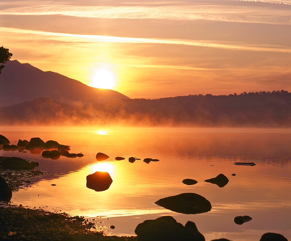 Mist rising on Derwent Water at sunrise, Lake District National Park, Cumbria, England, United Kingdom, Europe