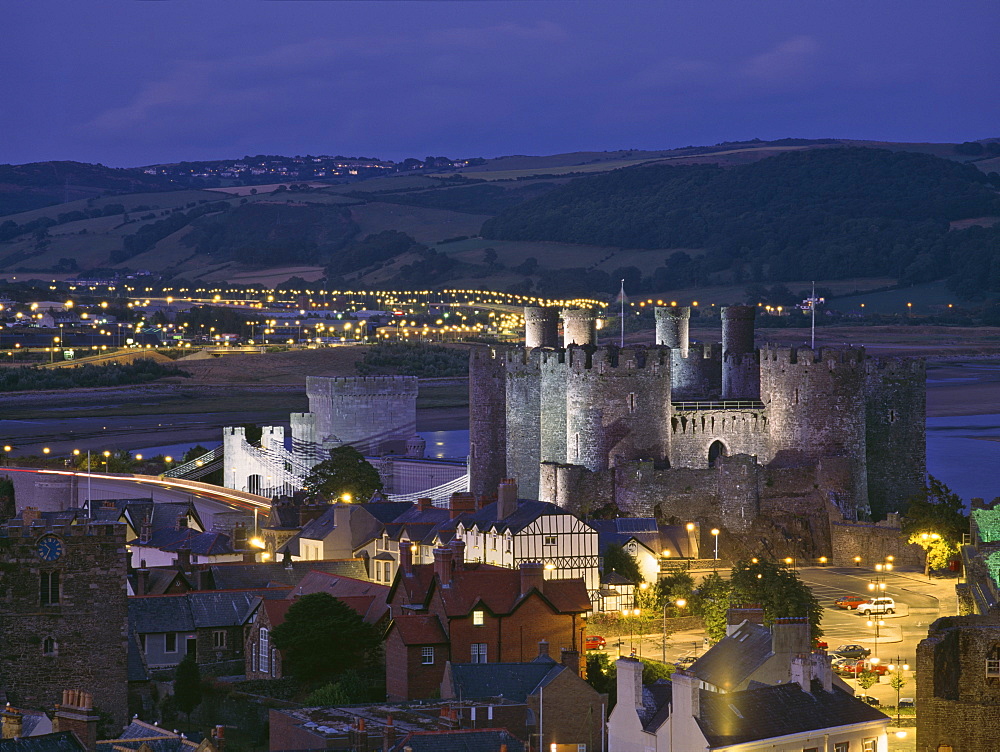 Floodlit Conwy Castle, UNESCO World Heritage Site, overlooking the town with the River Conwy estuary beyond at dusk, Gwynedd, North Wales, United Kingdom, Europe