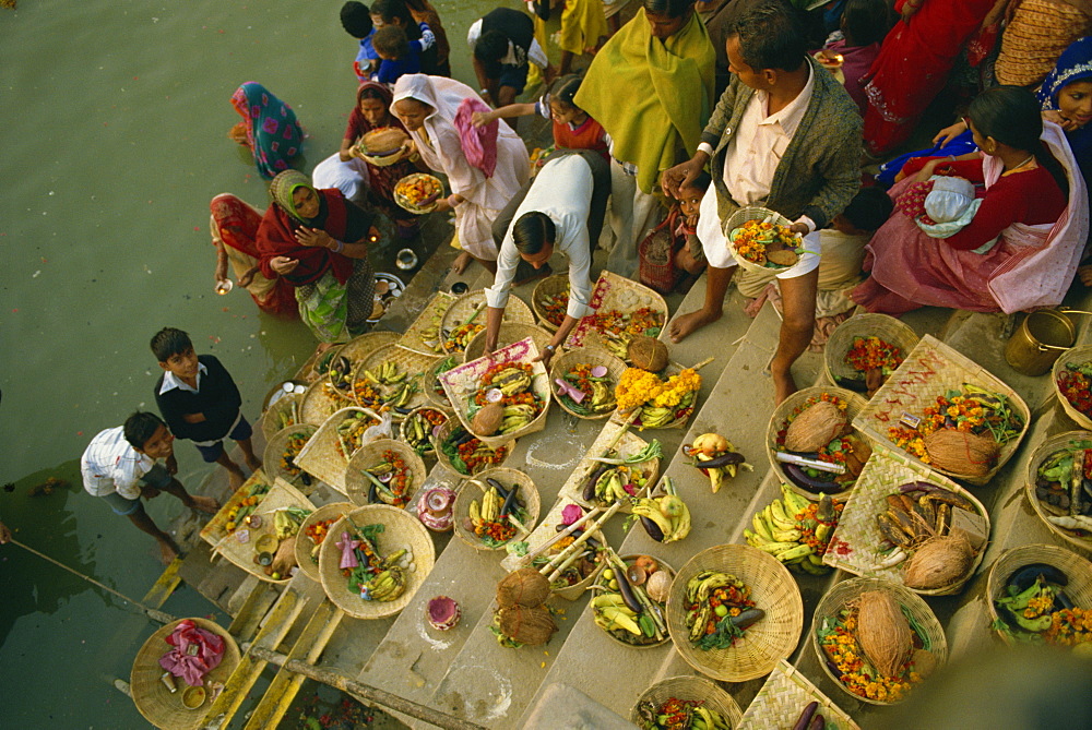 Offerings to the sun god Surya on the ghats during the Sun Worship Festival, Varanasi, Uttar Pradesh state, India, Asia