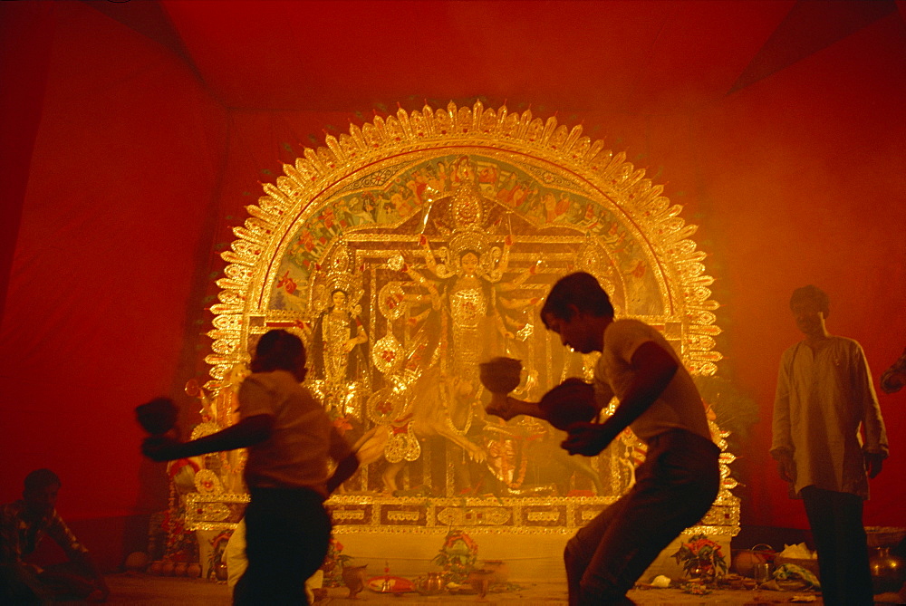 Dancing before the image of the ten armed warrior goddess Durga, Durga Puja Festival, Varanasi, Uttar Pradesh state, India, Asia