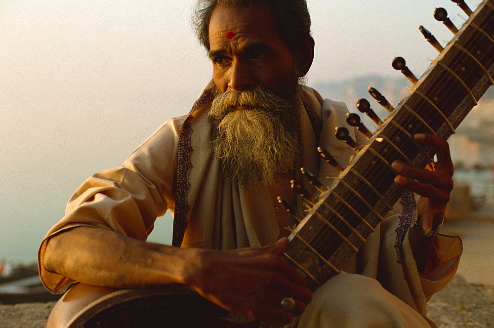 Sitar and player beside the Ganga River, Varanasi, Uttar Pradesh state, India, Asia