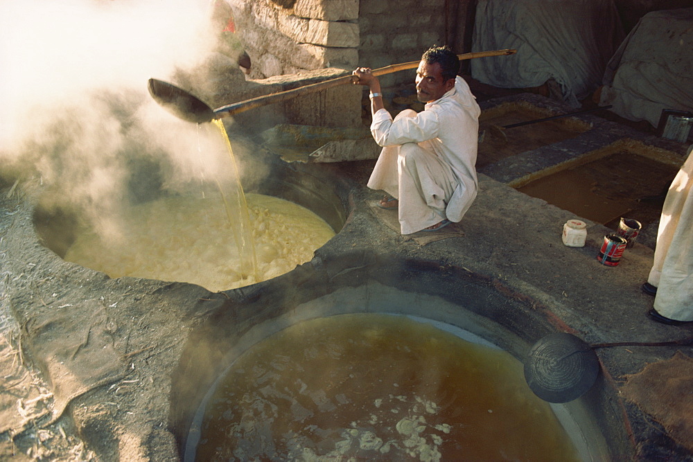 Boiling off water from cane juice to make jaggery (sugar), after sugar cane harvest, Gujarat state, India, Asia