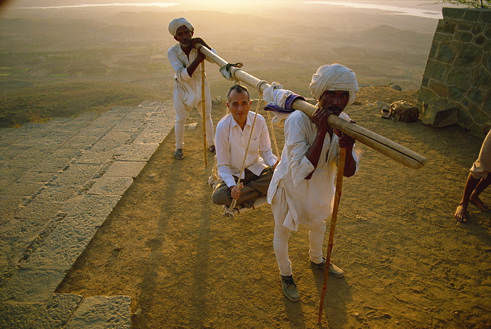 Jain pilgrim takes a ride up to the sacred temples of Palitana, Gujarat, India, Asia