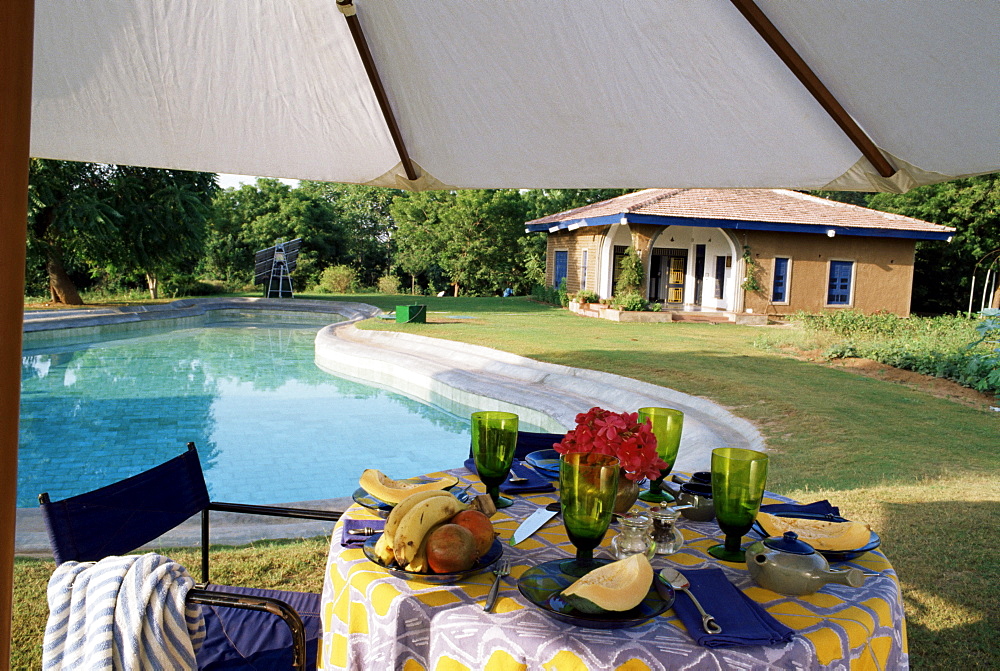 Eco friendly swimming pool and solar panels in background, residential home, near Ahmedabad, Gujarat, India. 