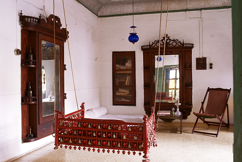 Seating area with traditional hitchkar suspended swing seat in restored traditional Pol house, Ahmedabad, Gujarat state, India, Asia