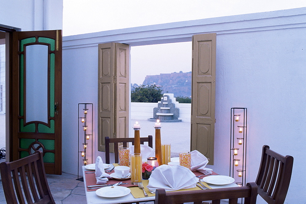 Private dining outside a bedroom suit with view of Gwalior fort in distance, Usha Kiran Palace Hotel, Gwalior, Madhya Pradesh state, India, Asia