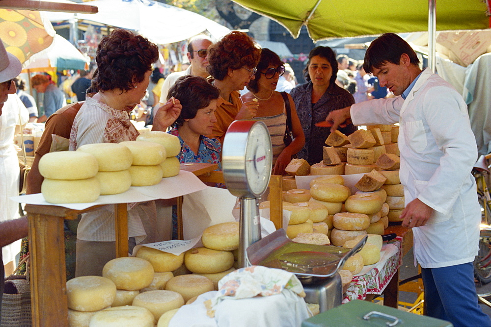 Shoppers tasting cheeses at a cheese stall in the market in Siena, Tuscany, Italy, Europe