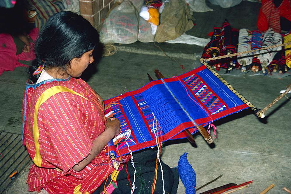 Indian woman weaving on a small loom, using acrylic dyes, in Oaxaca, Mexico, North America