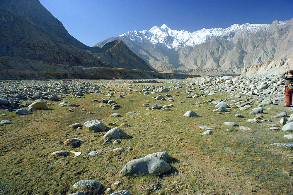 Rocky valley with snow capped mountains in the background on the Karakorum Highway on route to Pakistan, in Xinjiang Province, China, Asia