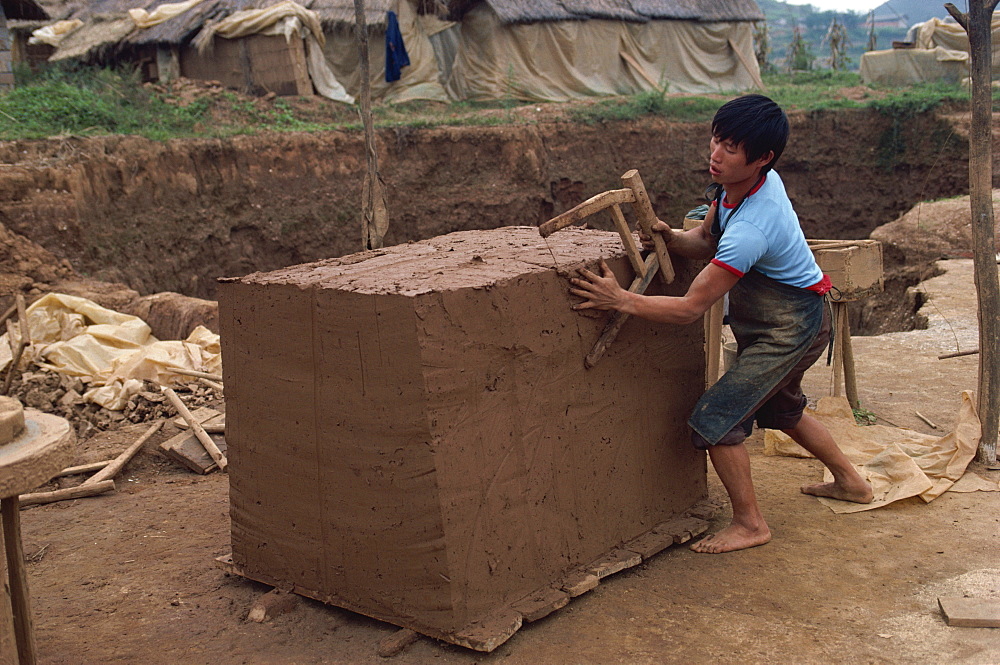 Cutting clay for tiles after it has been mixed, south east area, Guizhou, China, Asia