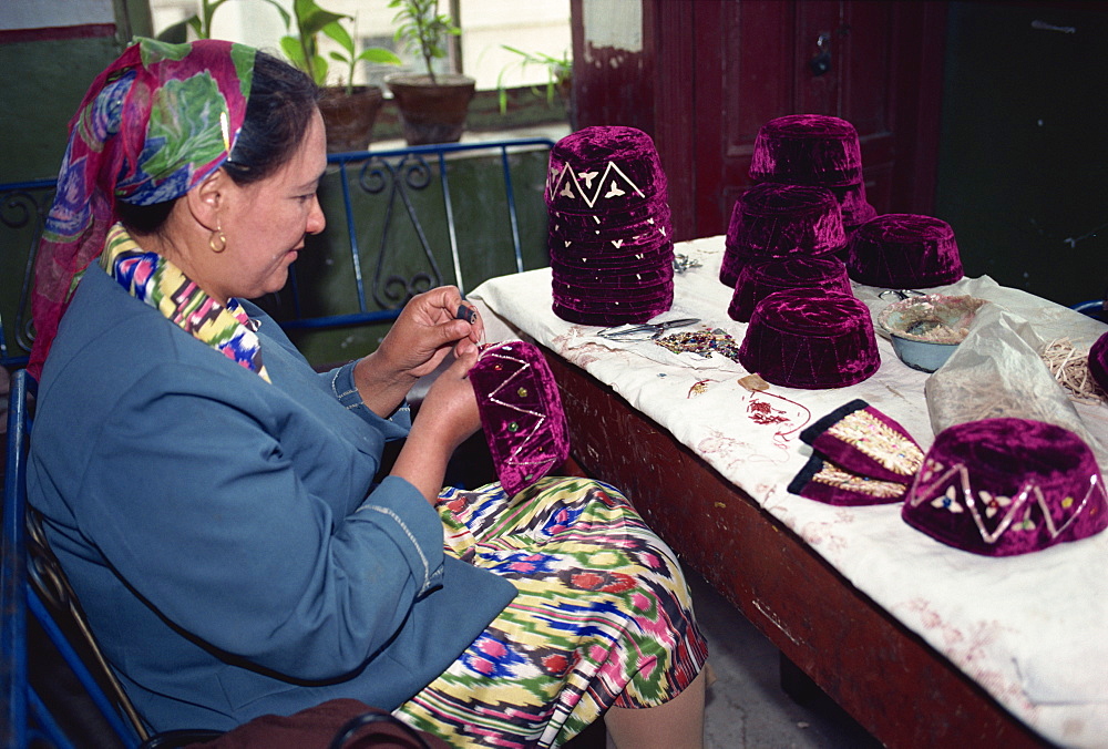 Uyghur woman making typical hats of the area, Kashi, China, Asia