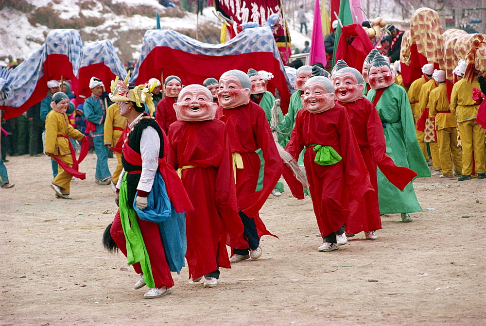 Crowds of costumed dancers celebrate Chinese New Year, Xining, Qinghai Province, China, Asia