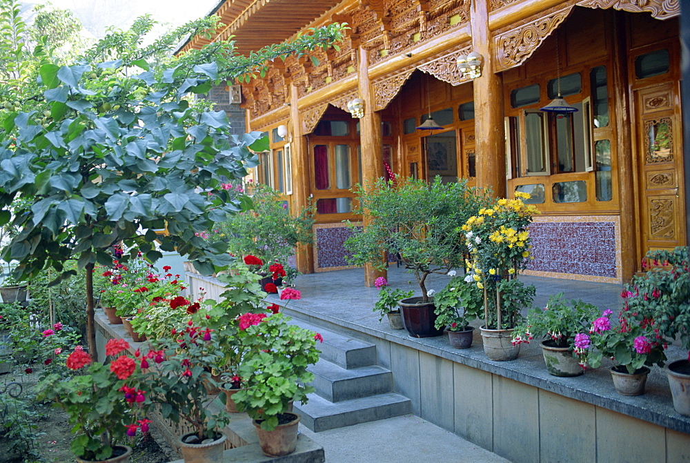 Pot plants, garden, and wooden Sala architecture in the north east of Qinghai, China, Asia