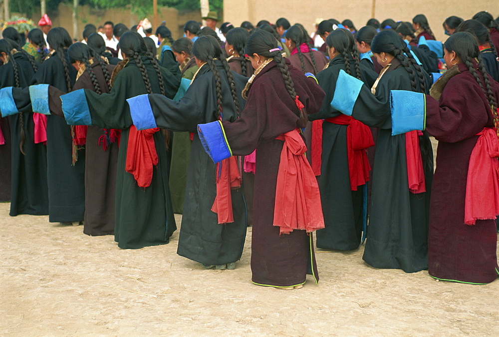 Tibetan women dancing during secular festival, Tongren, Qinghai, China, Asia