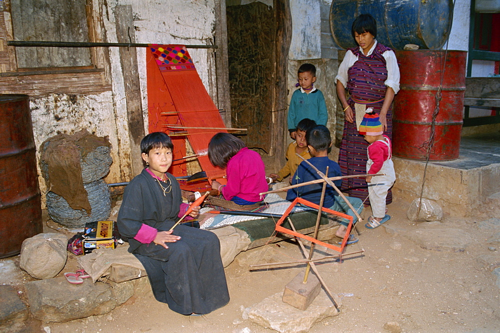 Young children learning to weave and spin at Duksun in east Bhutan, Asia