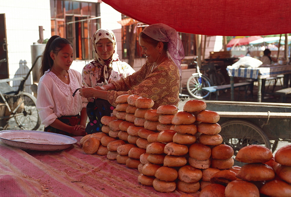 Uyghurs selling bread, Yining, Xinjiang, China, Asia