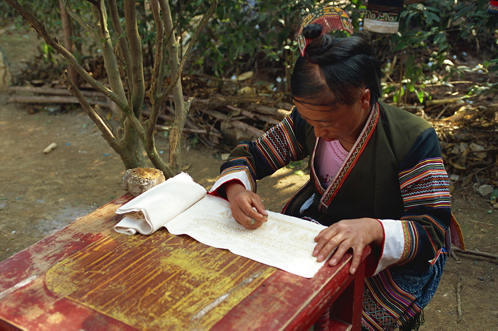 Miao girl doing wax resist, southern Guizhou, Guizhou, China, Asia