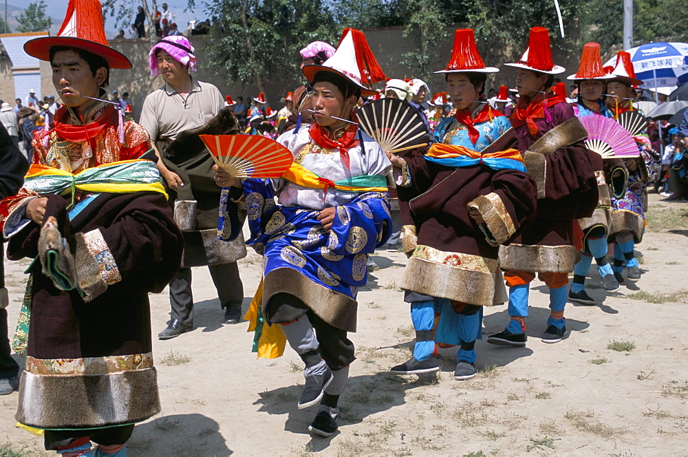 Tibetans dressed for religious shaman's ceremony, Tongren, Qinghai Province, China, Asia