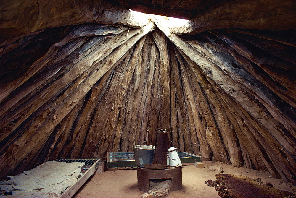 Cooking stove in interior of a Navajo dwelling in which three interlocking pinuon pine trunks support conical stack of mud covered logs, Arizona, United States of America, North America