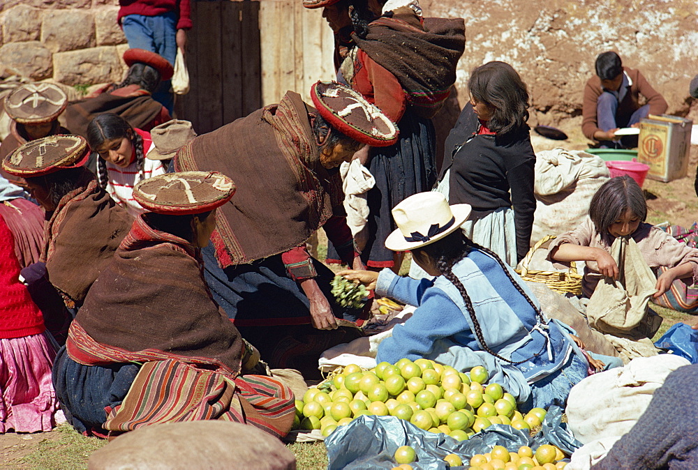 Groups of women selling fruit at the Sunday market at Chincheros in the Cuzco area, Peru, South America