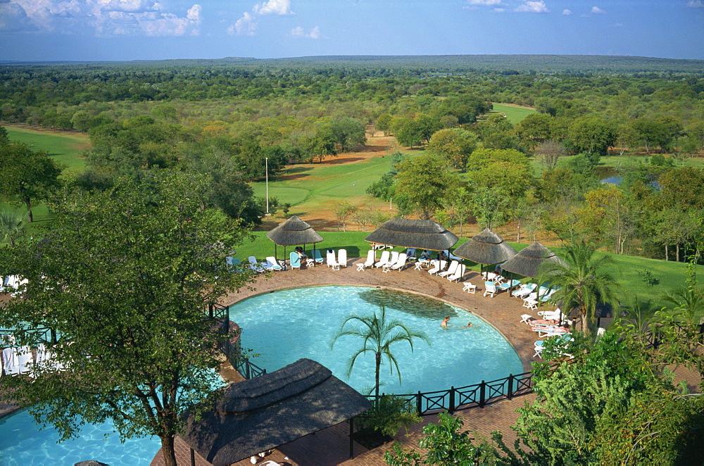 Aerial view over Elephant Hills Hotel swimming pool and golf course, near Victoria Falls, Zimbabwe, Africa