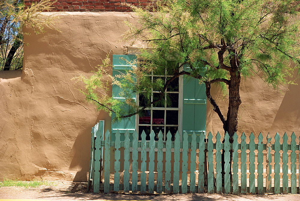 Detail of old adobe house with turquoise shutters and picket fence which traditionally bring good luck, Santa Fe, New Mexico, United States of America, North America