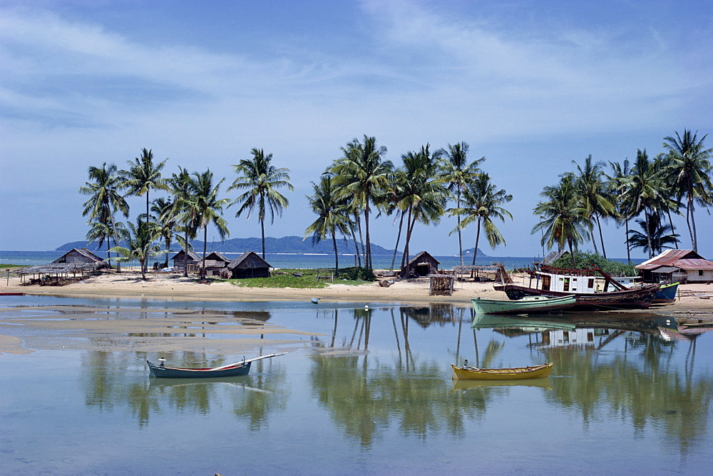 Palm trees and moored boats on the beach at Marang, on the east coast, Malaysia, Southeast Asia, Asia