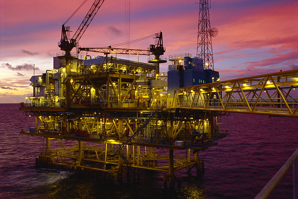 Oil rig illuminated at dusk, Gulf of Thailand, Thailand, Southeast Asia, Asia