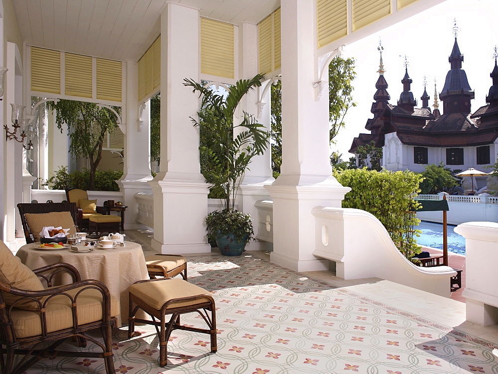 Outdoor dining on the balcony with a pool view at the Mandarin Oriental Dhara Dhevi in Chiang Mai, Thailand, Southeast Asia, Asia