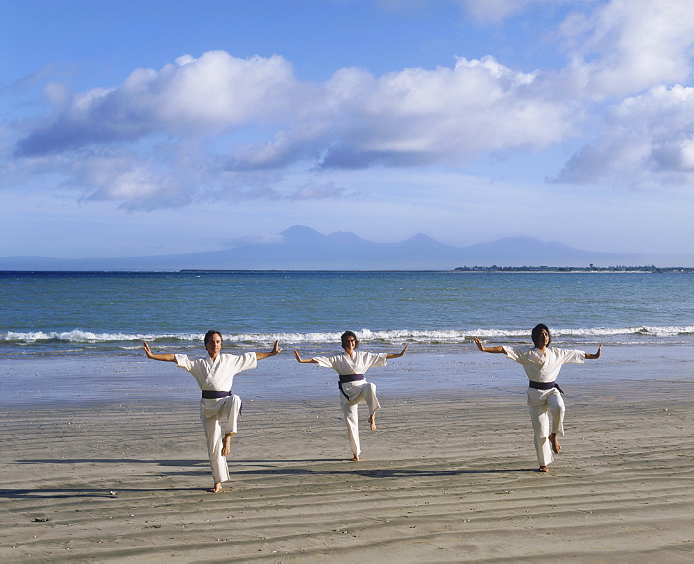 People performing White Crane Silat, an ancient martial art now used for exercise, on Jimbaran Beach, Bali, Indonesia, Southeast Asia, Asia