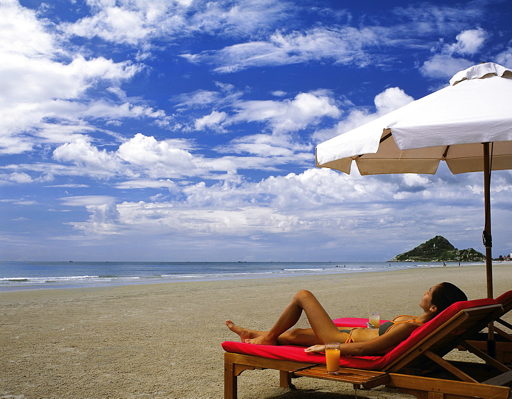 Woman relaxing on the beach at Hua Hin, Thailand, Southeast Asia, Asia