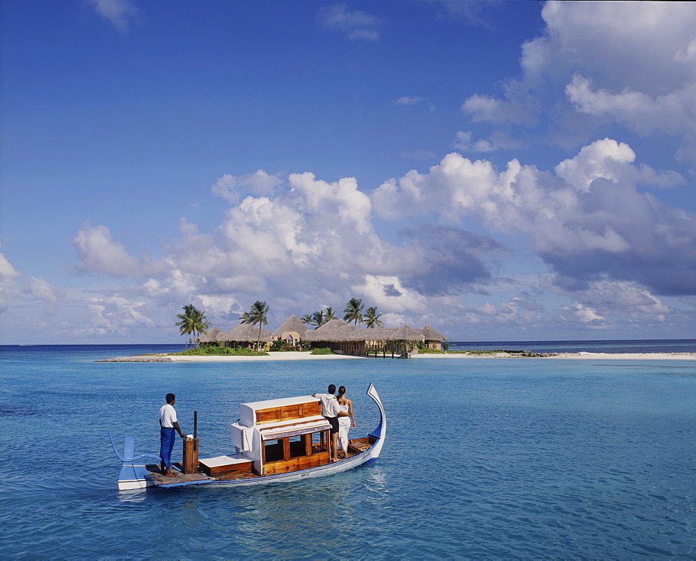 Couple ariving at the Four Seasons Spa in the Maldives, Indian Ocean, Asia