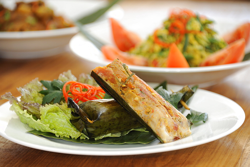 Balinese food, including Ikan pepes, fish grilled in a banana leaf packet, Bali, Indonesia, Southeast Asia, Asia