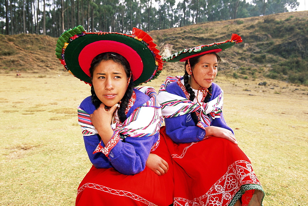 Portrait of two young local women in traditional dress, near Cuzco, Peru, South America