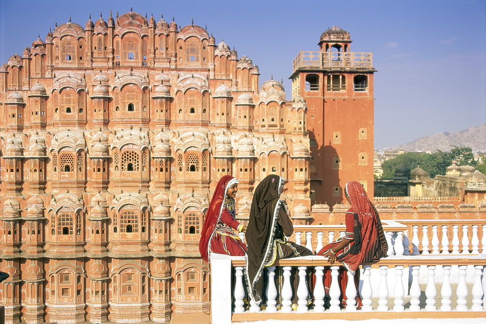 Women in saris in front of the facade of the Palace of the Winds (Hawa Mahal), Jaipur, Rajasthan state, India, Asia