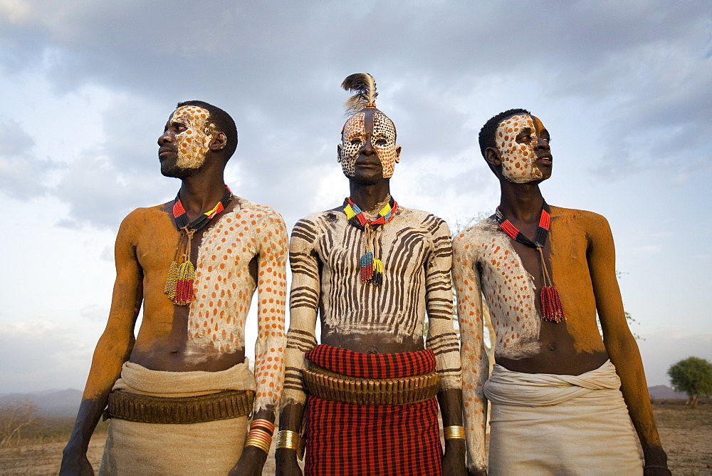 Karo tribesmen with face and body painting imitating the spotted plumage of the guinea fowl, Omo river, Lower Omo Valley, Ethiopia, Africa