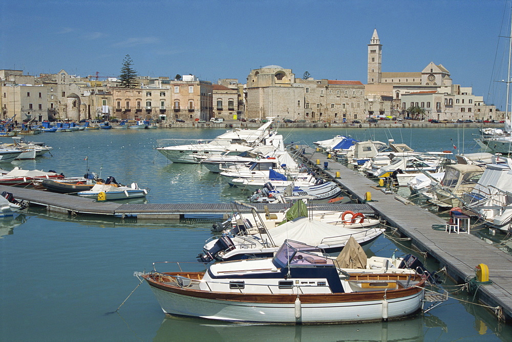 Boats in the harbour, with the the 12th century cathedral of San Nicola Pellegrino in the background in the town of Trani, Puglia, Italy, Mediterranean, Europe