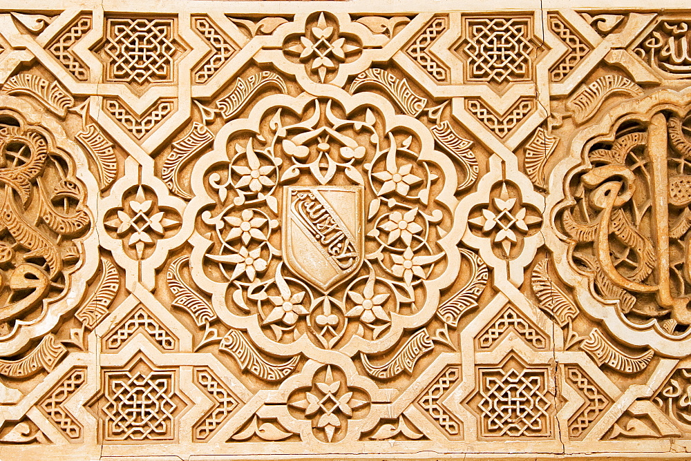 Atauriques (Moorish plaster work) in the Nasrid palace showing the shield of al Ahmur used as a decorative theme, Alhambra, UNESCO World Heritage Site, Granada, Andalucia, Spain, Europe