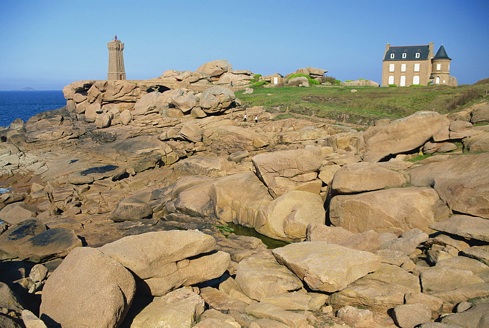 Rocks on the coast and the lighthouse at Ploumanach, on the Cote de Granit Rose, on the Cotes d'Amor, Brittany, France, Europe