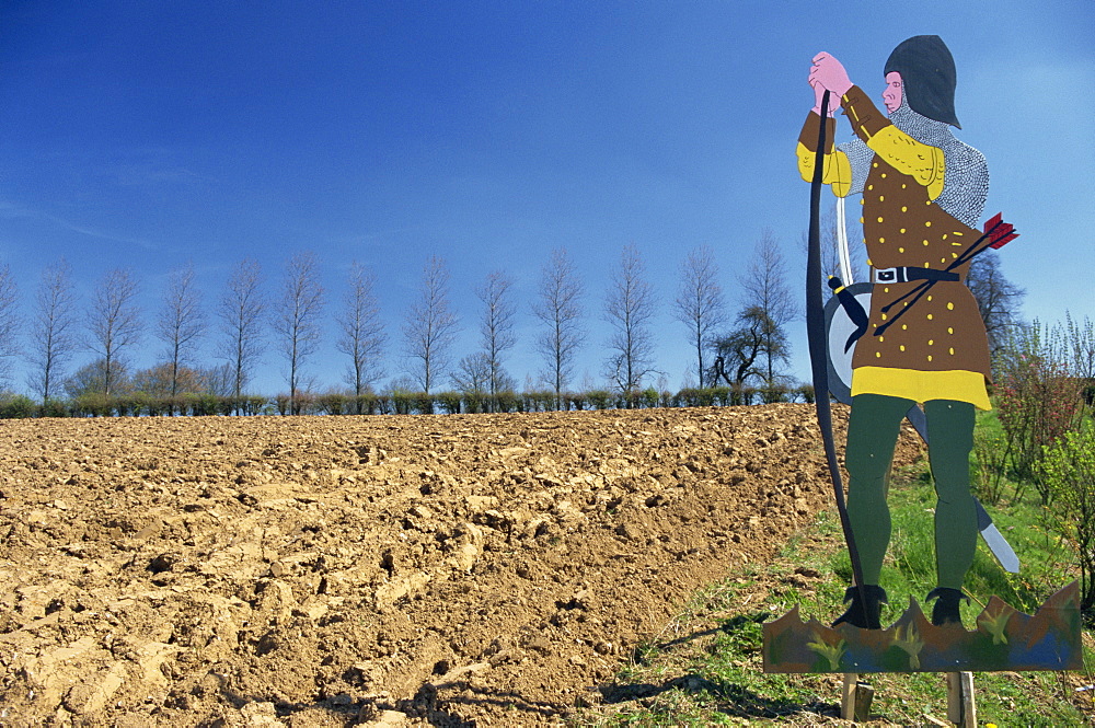 Figure on a sign marks the site of the Battle of Agincourt, in the Nord Pas de Calais, France, Europe