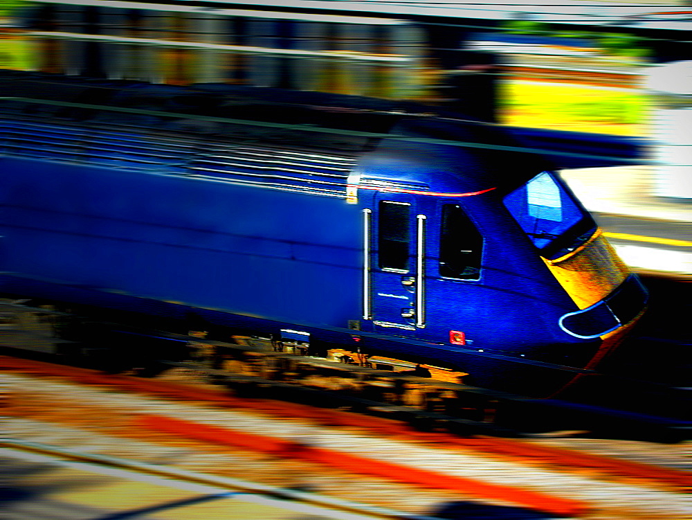 A blue locomotive travelling at speed