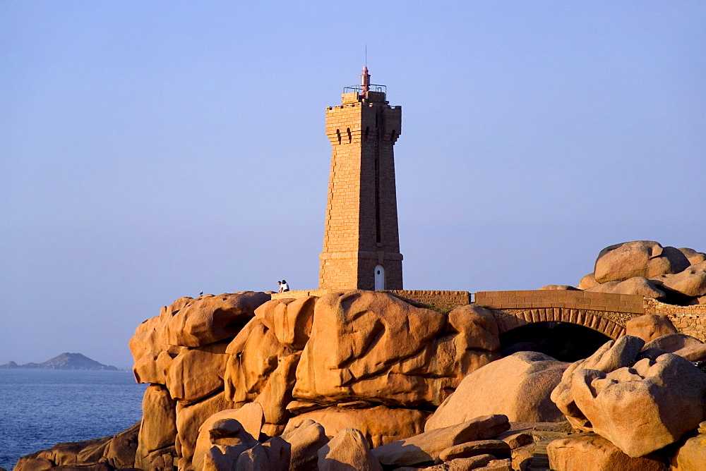 Sunset over rocks and lighthouse at Pars-Kamor, Ploumanach, Breton Corniche, Cote de Granit Rose, Cotes d'Armor, Brittany, France, Europe