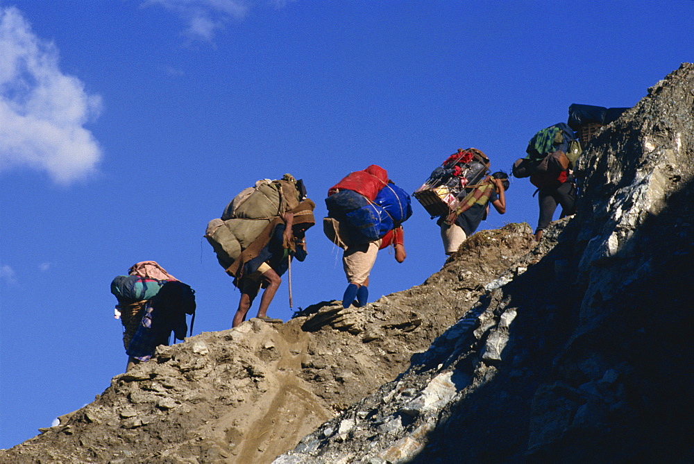 Trek porters on eroded trail to Ghorapani Pass near Chitre, Nepal, Asia