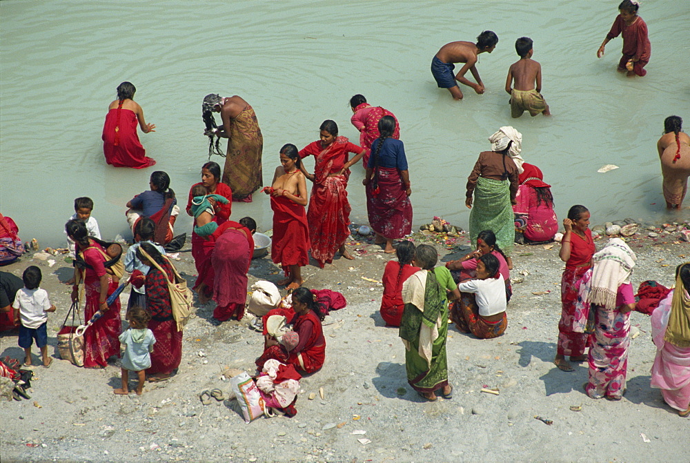 Ritual cleansing in Seti Khola, a tributary of the Ganges, for Nepali New Year, Pokhara, Nepa, Asia