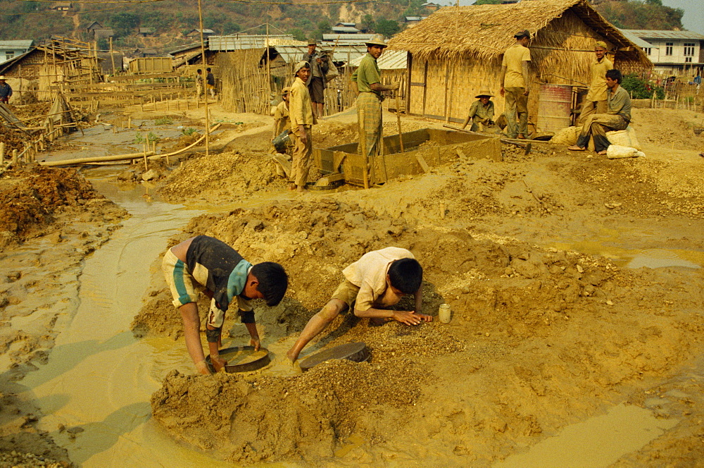 Children sieving and washing small gems from mine waste, Mogok ruby mines, near Mandalay, Myanmar (Burma), Asia