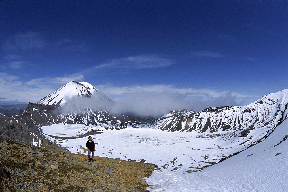 Late winter hiker on Tongariro Crossing, Mount Ngauruhoe and South Crater, Tongariro National Park, UNESCO World Heritage Site, Taupo, South Auckland, North Island, New Zealand, Pacific