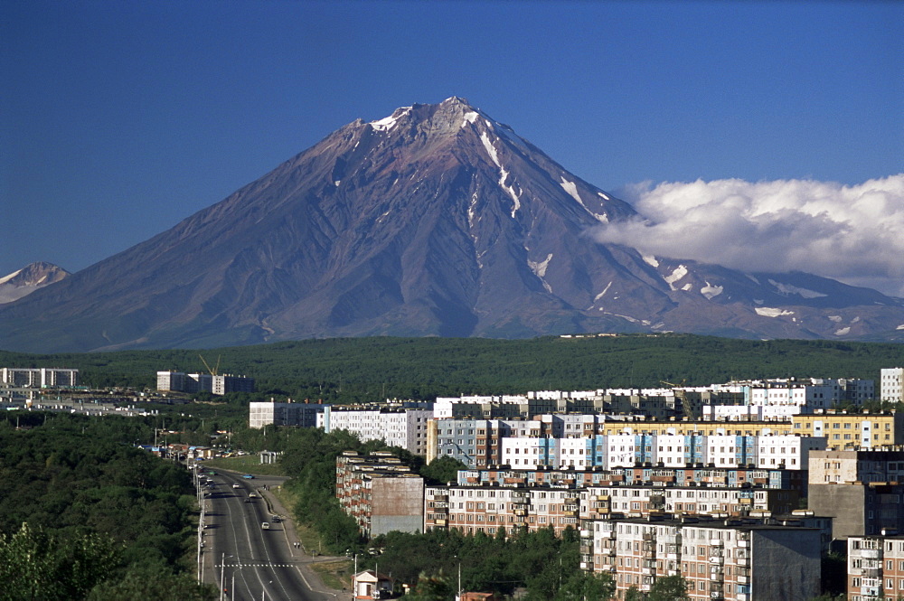 Koryaksky volcano. UNESCO World Heritage Site, behind Stalinist suburban flats, Petropavlovsk, Kamchatka, Eastern Siberia, Russia, Eurasia