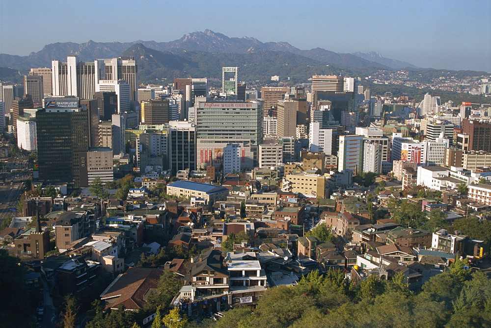 City centre tower blocks seen from Namsan Park with Pukansan granite hills just beyond, Seoul, South Korea, Asia