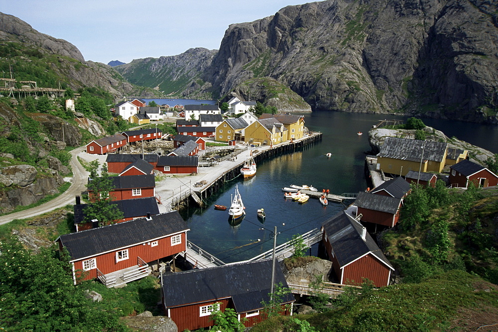 Wooden red houses on stilts over water at the fishing village of Nusfjord, Lofoten Islands, Norway, Scandinavia, Europe